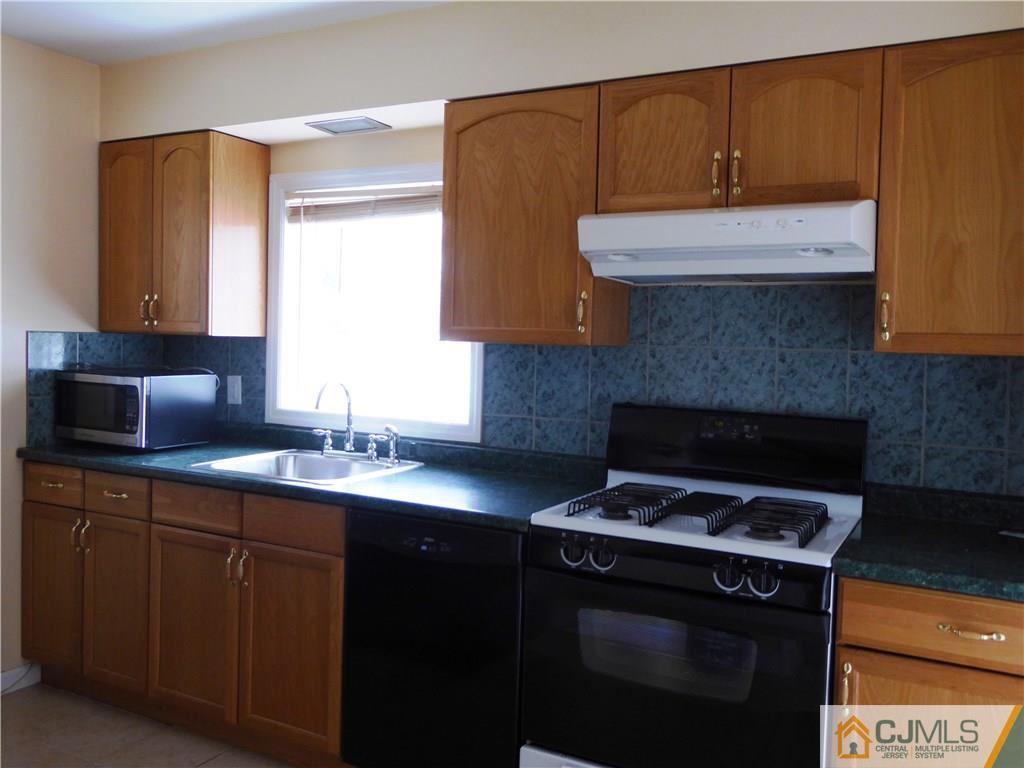 38 Stony Road West Edison, NJ 08817 - Photo 28 of 42 a kitchen with a sink a stove and cabinets