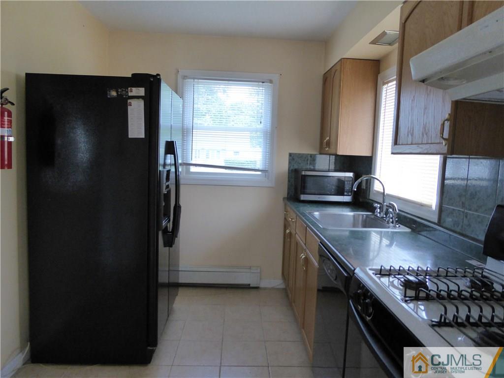 38 Stony Road West Edison, NJ 08817 - Photo 7 of 42 a kitchen with a sink stove and refrigerator
