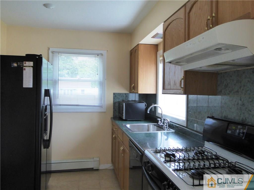 38 Stony Road West Edison, NJ 08817 - Photo 8 of 42 a kitchen with stainless steel appliances granite countertop a sink stove and refrigerator