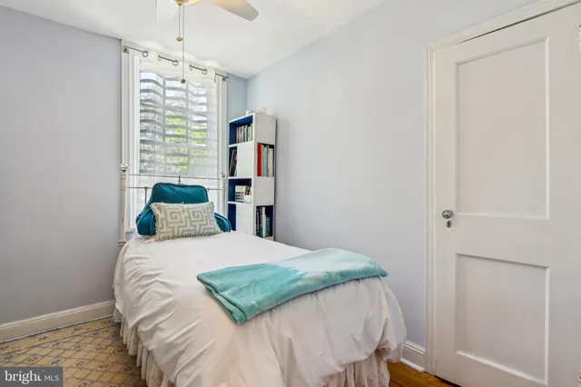 a view of a house with a big yard and large trees