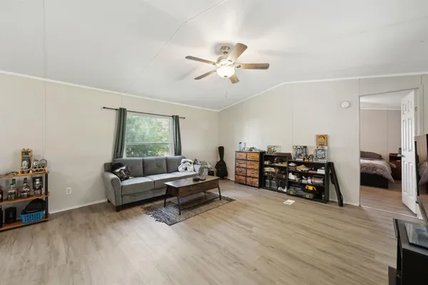 a living room with furniture and a wooden floor