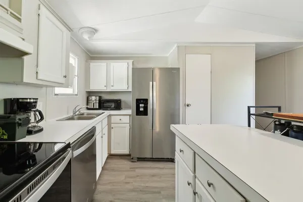 a kitchen with a refrigerator stove and sink