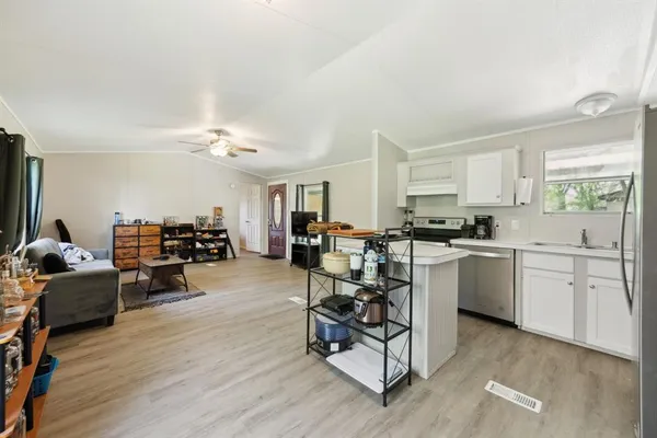 a kitchen with white cabinets and stainless steel appliances