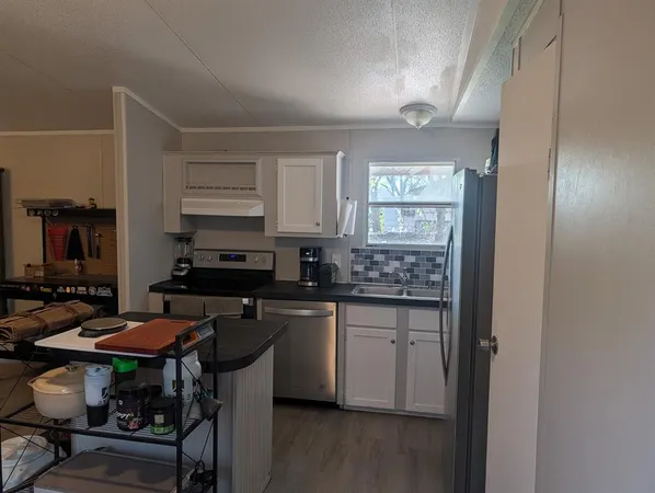a kitchen with a sink cabinets and window