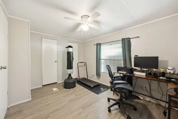 a view of a workspace with furniture and a window