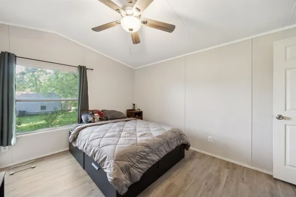a bedroom with a large bed and a large window