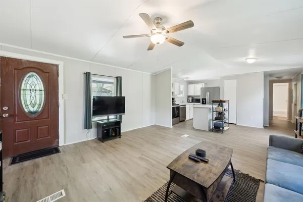 a living room with furniture and a flat screen tv