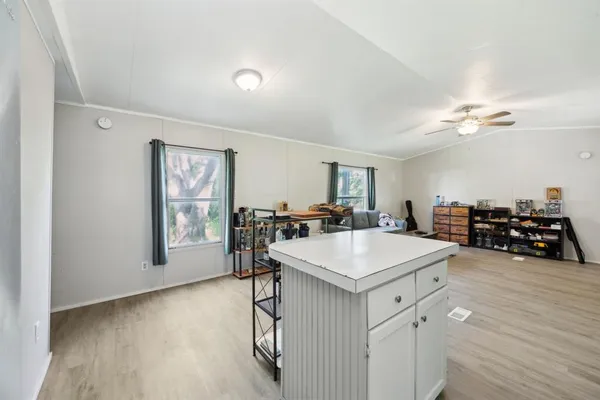 a view of a room with workspace and wooden floor