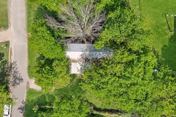 an aerial view of a house with a yard