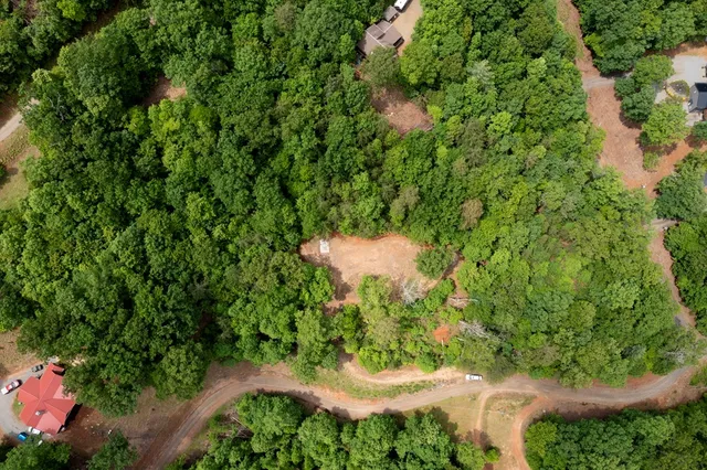 a backyard of a house with a yard and outdoor seating