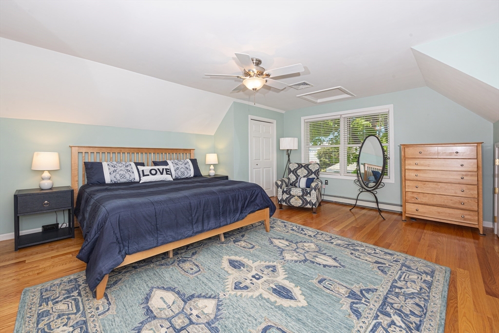 59 J Street Hull, MA 02045 - Photo 27 of 35 a bedroom with a bed and wooden floor