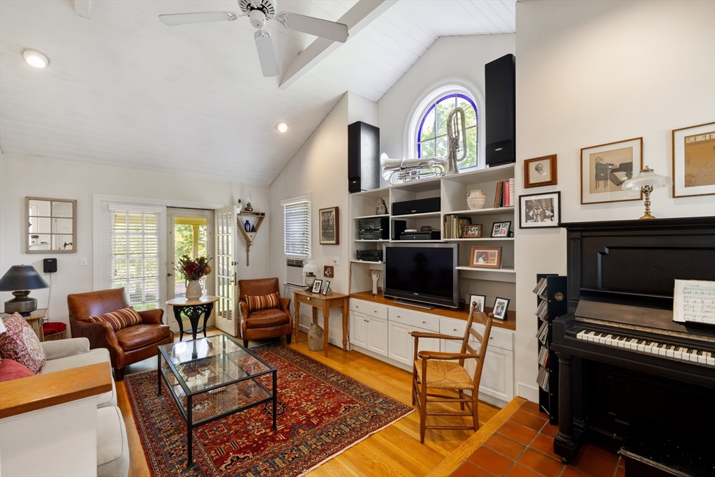 4 Longfellow Road Lexington, MA 02420 - Photo 11 of 37 a living room with furniture a fireplace and a flat screen tv