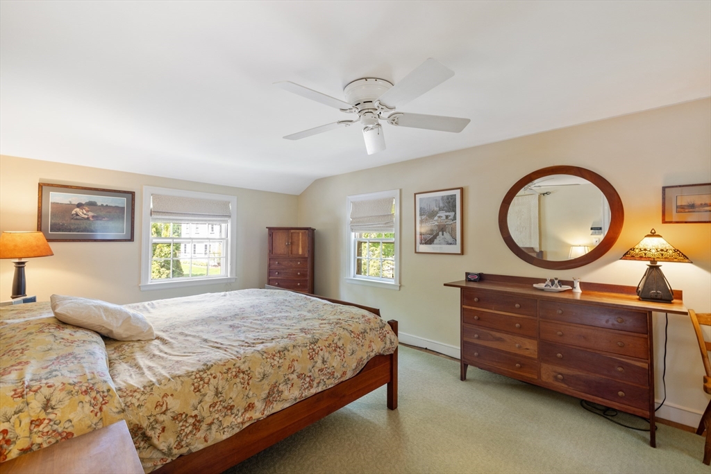 4 Longfellow Road Lexington, MA 02420 - Photo 21 of 37 a bedroom with a bed a mirror on dresser and a window