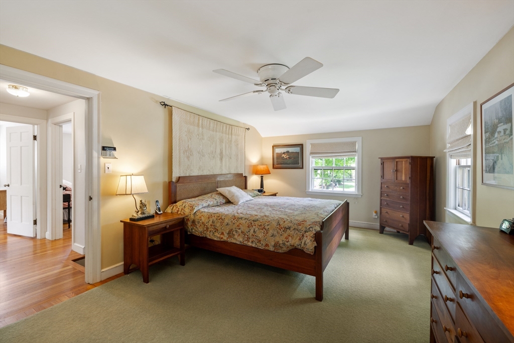 4 Longfellow Road Lexington, MA 02420 - Photo 22 of 37 a bedroom with a bed chandelier and a window