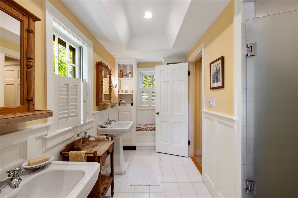 4 Longfellow Road Lexington, MA 02420 - Photo 24 of 37 a bathroom with a sink a toilet and a mirror