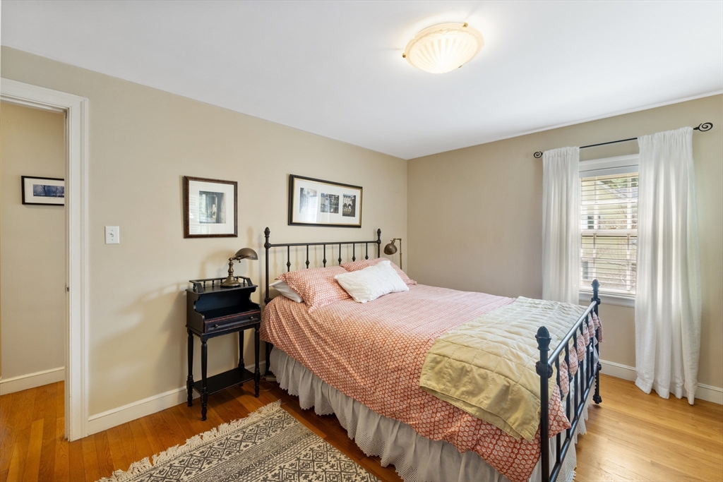 4 Longfellow Road Lexington, MA 02420 - Photo 25 of 37 a bedroom with a bed and a table in it