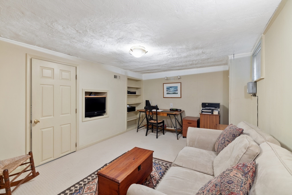 4 Longfellow Road Lexington, MA 02420 - Photo 27 of 37 a living room with furniture and a flat screen tv