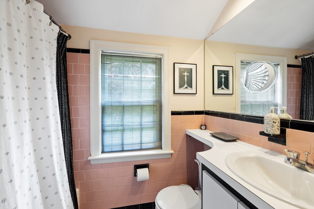 4 Longfellow Road Lexington, MA 02420 - Photo 31 of 37 a bathroom with a granite countertop sink toilet and painting on the wall