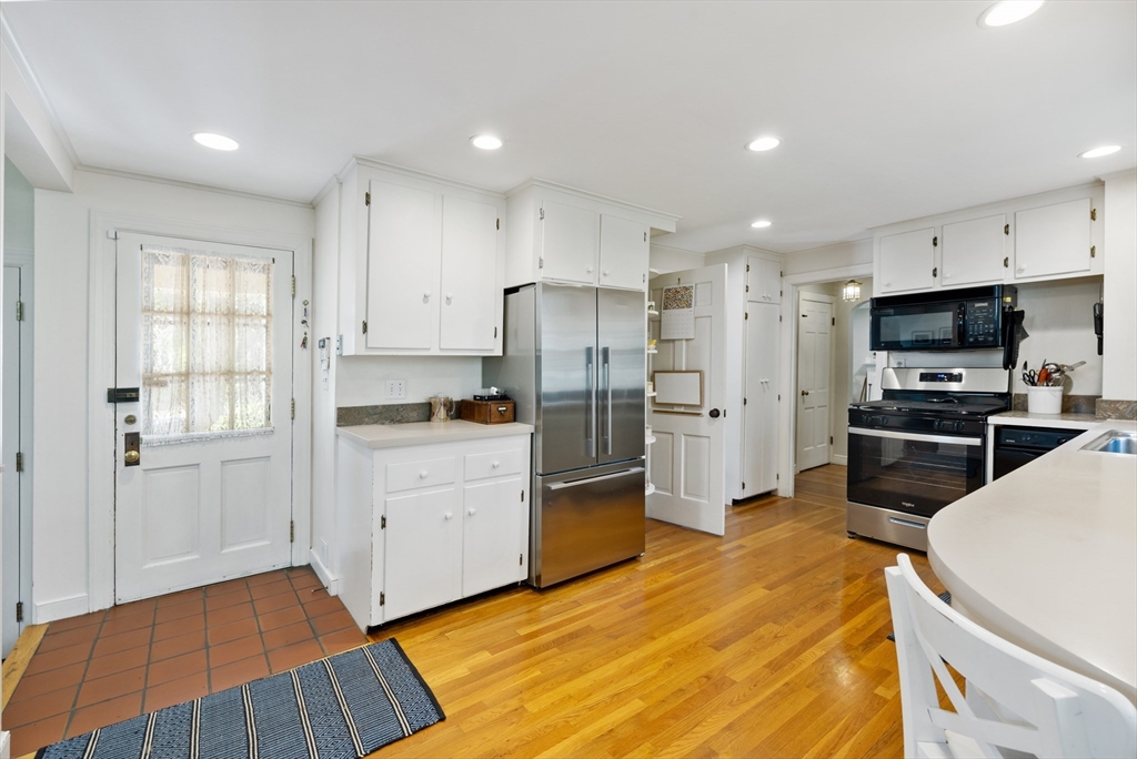 4 Longfellow Road Lexington, MA 02420 - Photo 4 of 37 a kitchen with white cabinets and stainless steel appliances