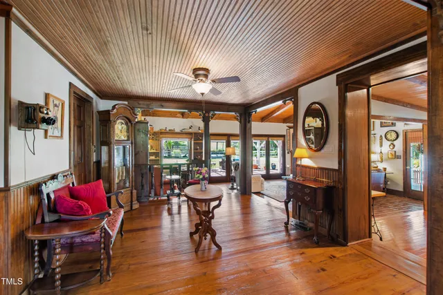 a living room with furniture a chandelier and a fireplace
