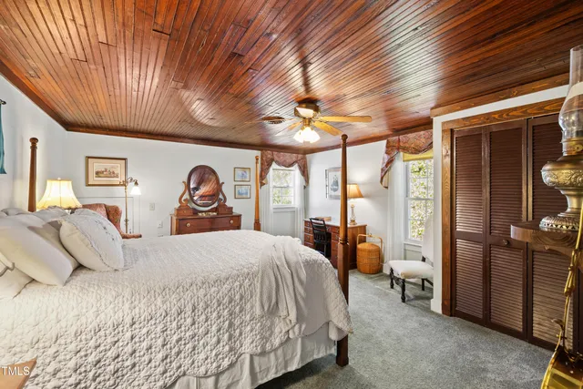 a kitchen with a refrigerator a stove a sink dishwasher and white appliances with wooden floor