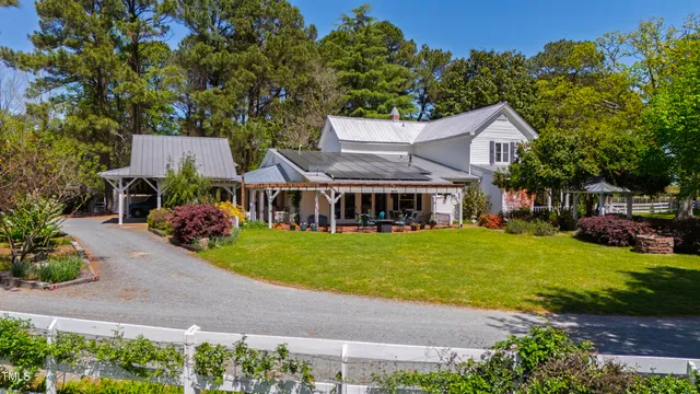 a living room with furniture a ceiling fan and a flat screen tv