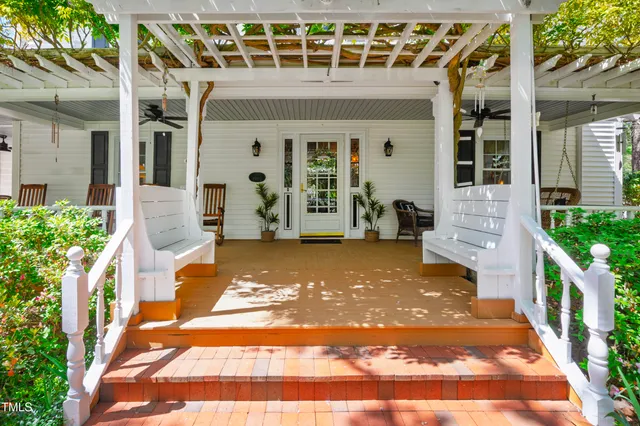 a living room with furniture a rug and a chandelier