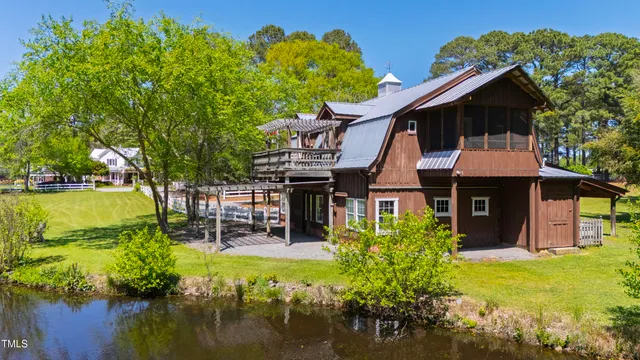 an aerial view of residential houses with outdoor space and parking
