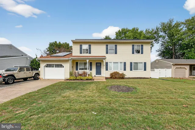 a view of a house with a large window and a yard