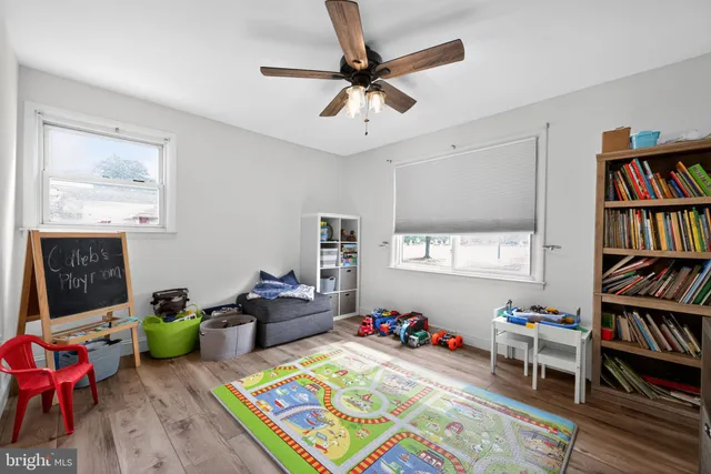 a room with furniture a rug and a book shelf