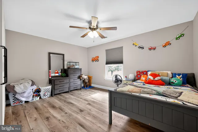 a bedroom with furniture and a wooden floor
