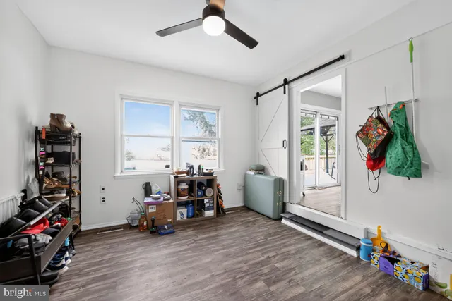 a view of a bedroom with baby crib and a window