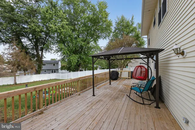 a view of a roof deck with wooden floor and fence