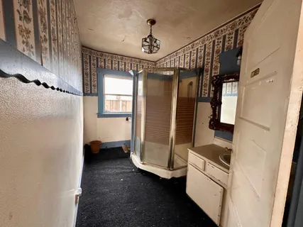 a view of hallway with stairs and wooden floor