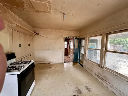 a kitchen with granite countertop a stove and a refrigerator