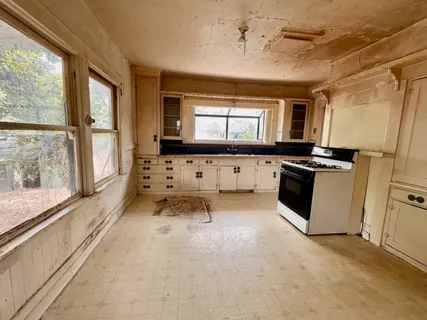 a kitchen with granite countertop a stove and a refrigerator