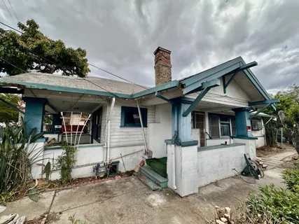 a view of a house with more windows and potted plants