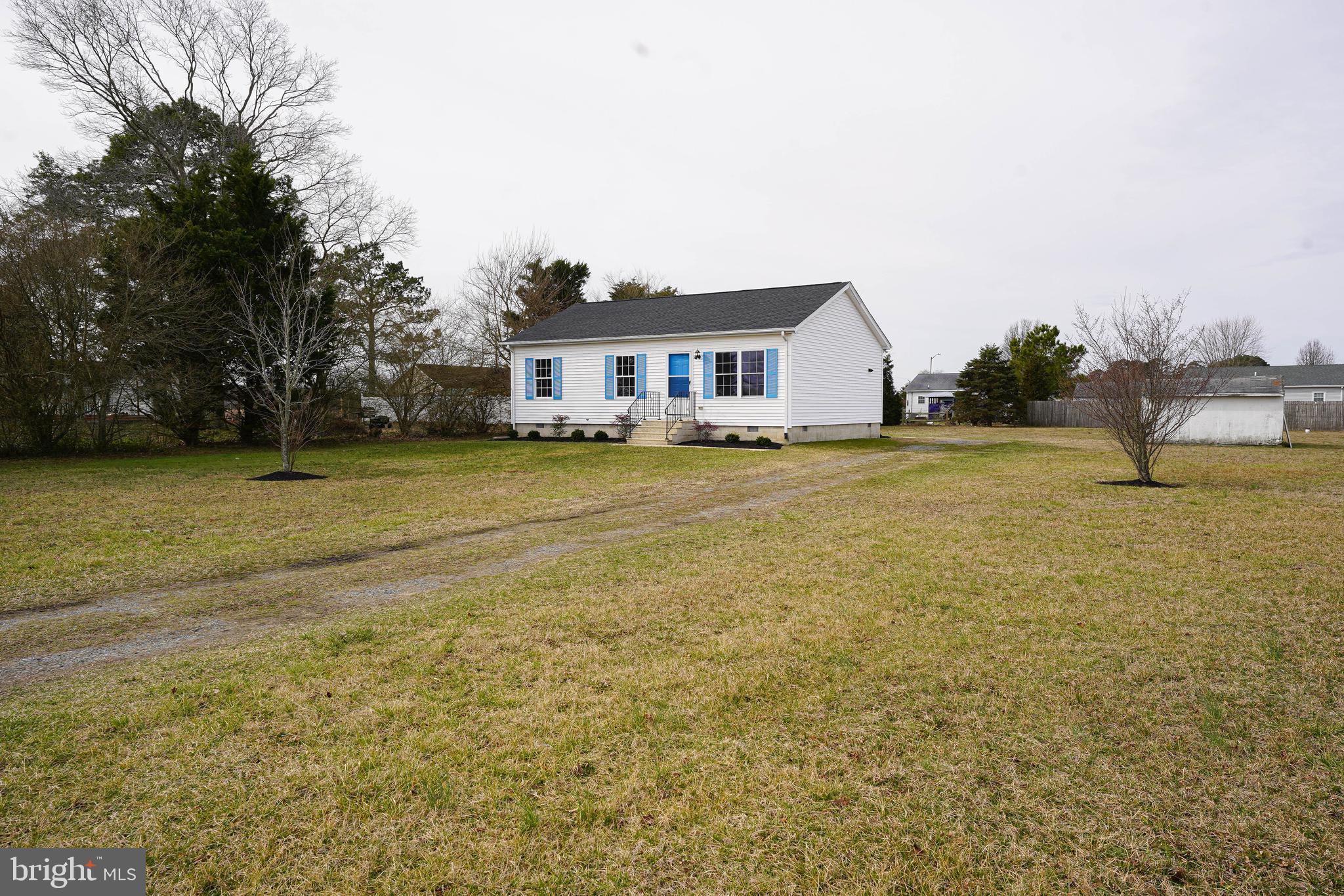 7526 Bethel Road Willards, MD 21874 - Photo 2 of 34 a view of a house with a yard and a large tree