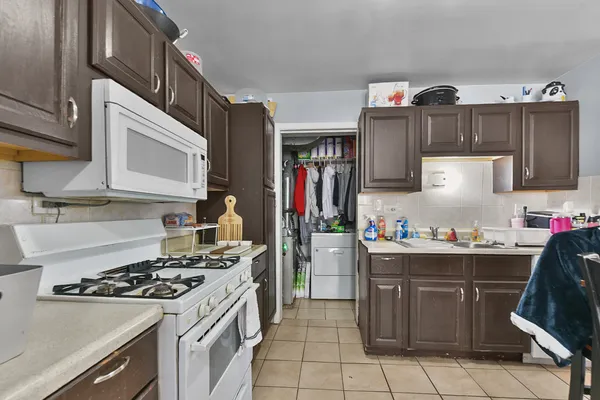 a kitchen with stainless steel appliances a refrigerator sink and microwave