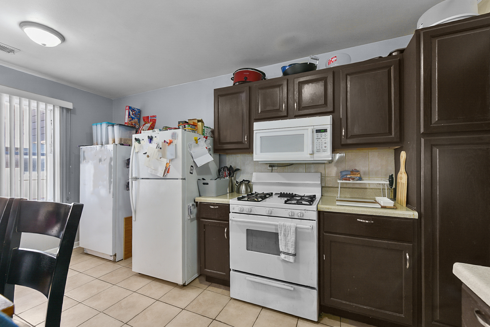 12746 South Kenneth Avenue, Unit 2F Alsip, IL 60803 - Photo 9 of 14 a kitchen with stainless steel appliances a refrigerator sink and microwave