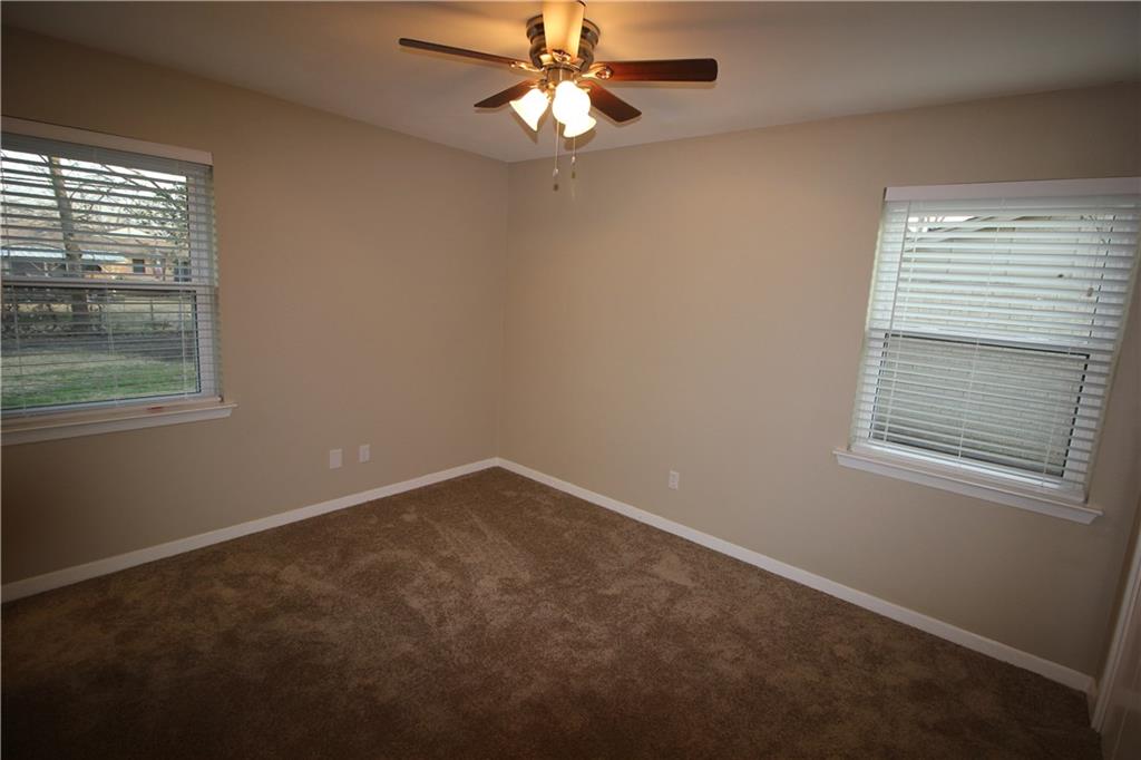 3532 Antilles Drive Mesquite, TX 75150 - Photo 11 of 18 an empty room with a window and a fan
