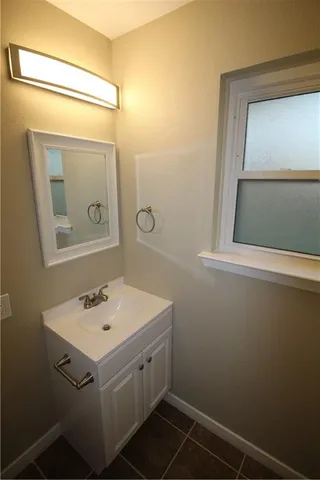 a bathroom with a sink a toilet and mirror