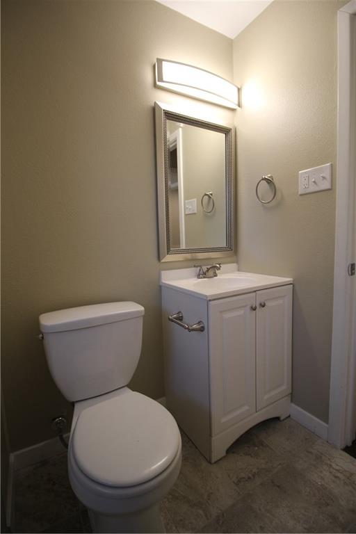 3532 Antilles Drive Mesquite, TX 75150 - Photo 16 of 18 a bathroom with a toilet sink and mirror