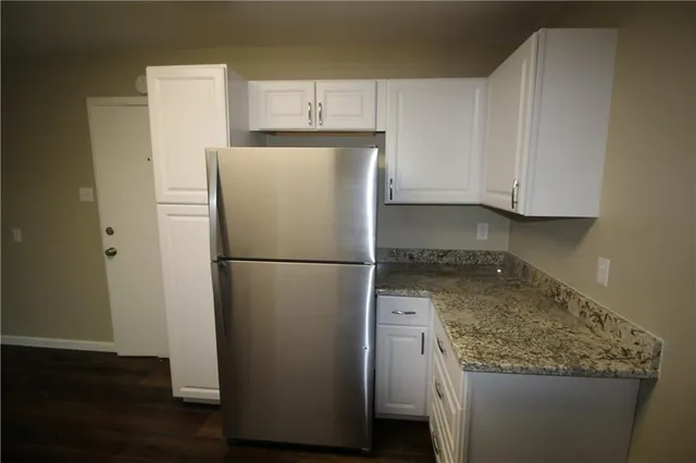 a white refrigerator freezer sitting inside of a kitchen