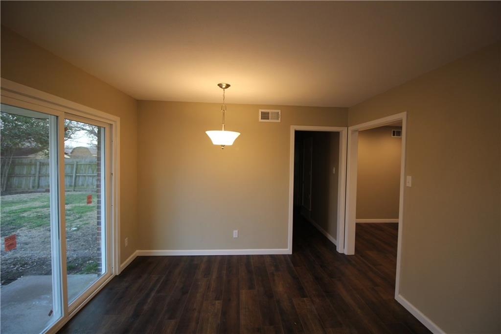 3532 Antilles Drive Mesquite, TX 75150 - Photo 7 of 18 an empty room with wooden floor and sliding door