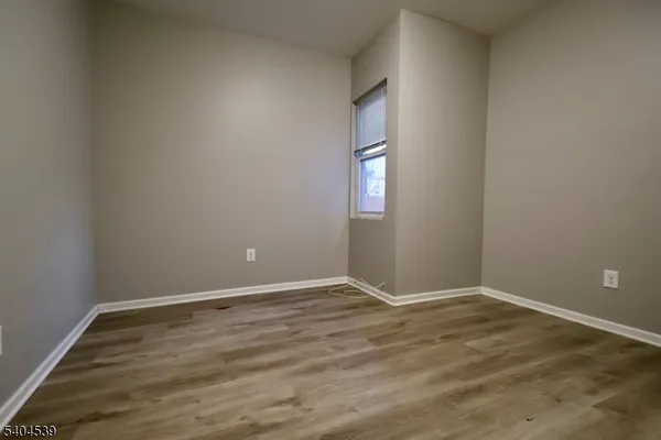 an empty room with wooden floor and white doors