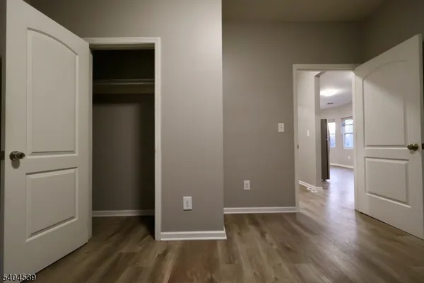 wooden floor in an empty room and a mirror