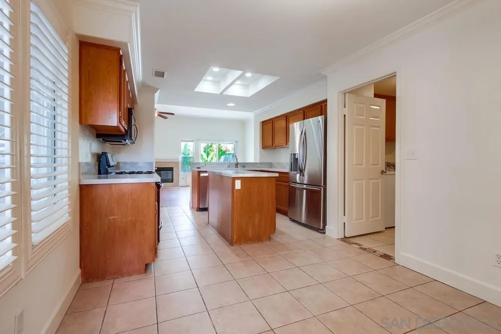 3924 Tortuga Cove Oceanside, CA 92058 - Photo 13 of 42 a kitchen with stainless steel appliances granite countertop a refrigerator and a stove