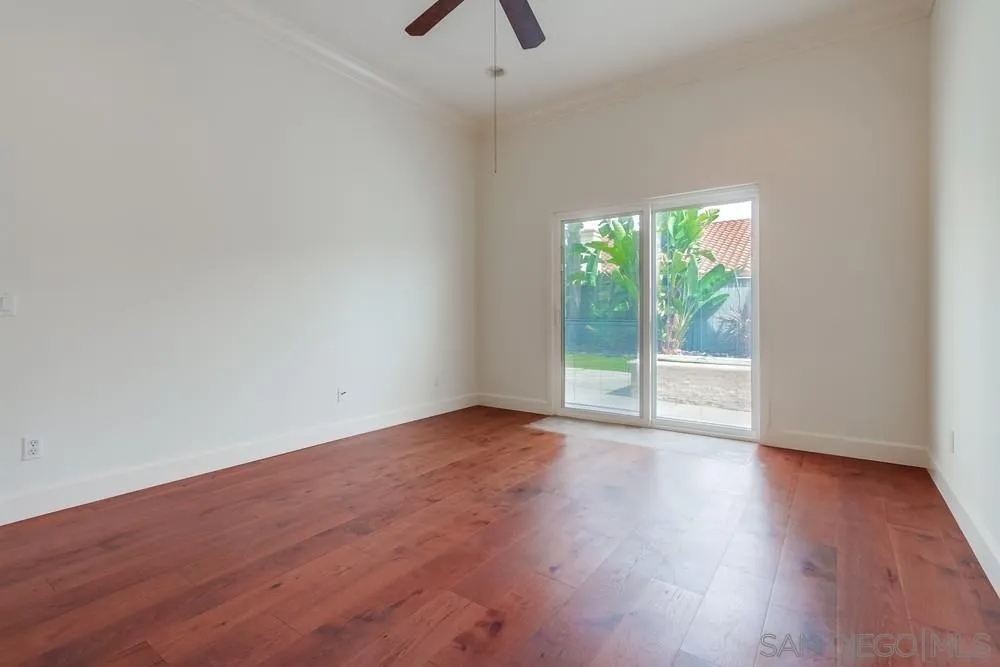 3924 Tortuga Cove Oceanside, CA 92058 - Photo 16 of 42 a view of an empty room with wooden floor and a window