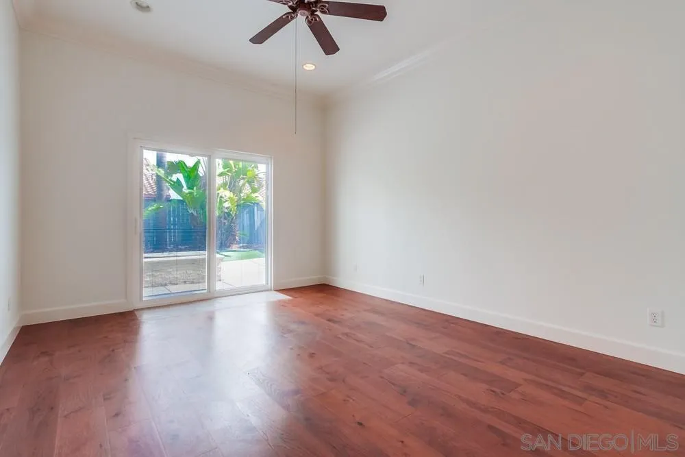 3924 Tortuga Cove Oceanside, CA 92058 - Photo 17 of 42 an empty room with wooden floor and windows